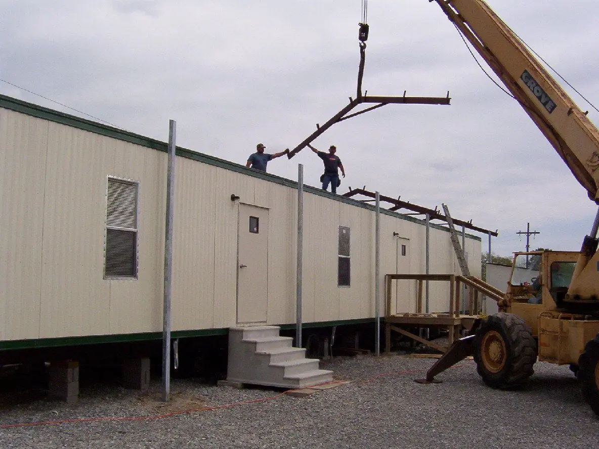 Sade Construction crew and crane erecting a steel framed commercial building roof structure