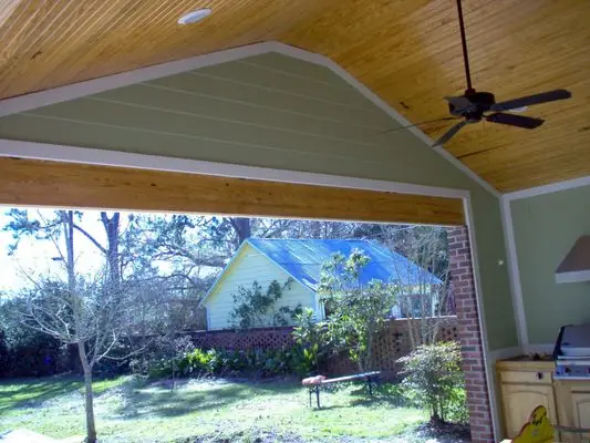 Wider interior angle of the same finished outdoor kitchen, showing the built-in cabinetry running along the wall
